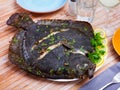 Close view of baked flounder on plate with parsley
