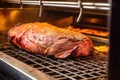 close view of a brisket being probed on a commercial grill Royalty Free Stock Photo