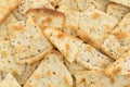 Close view of broken seasoned pizza crust chips