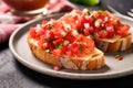 close view of bruschetta with pickled garlic on a crisscrossed napkin