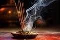 close view of a burning incense stick with smoke