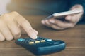 Business man hand calculating his monthly expenses during tax season Royalty Free Stock Photo