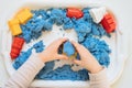 Close view of child`s hands playing with kinetic sand. Royalty Free Stock Photo