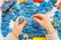 Close view of child`s hands playing with kinetic sand. C Royalty Free Stock Photo