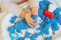 Close view of child`s hands playing with kinetic sand. Royalty Free Stock Photo