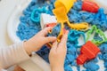 Close view of child`s hands playing with kinetic sand. Royalty Free Stock Photo