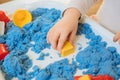 Close view of child`s hands playing with kinetic sand. Royalty Free Stock Photo