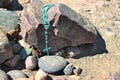 Necklace of a christian cross over a stone. Rosary beads