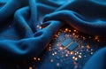 Close view of computer microchip on circuit board. Blue fabric drapes over electronic component glowing with orange light. Royalty Free Stock Photo