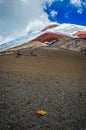 Close view of the Cotopaxi volcano, it`s slopes, rocks and safe house, on an cloudy yet sunny day, Cotopaxi National Park, Ecuador