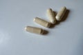 Close view of four beige capsules of Saccharomyces boulardii probiotic