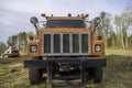 Close view of the front of an orange truck at construction site Royalty Free Stock Photo