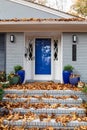 Close view of front porch and steps of a residential home with a deep layer of fall leaves, leaf litter removal service needed Royalty Free Stock Photo