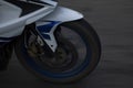 A close view of a front wheel of a motorbike
