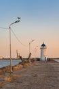 Close view of the Genoese lighthouse with a blue roof, from the pier