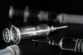 Close view of the glass syringes on a black background. Medicine and health concept. Vaccine against viruses. Needle and drugs. Royalty Free Stock Photo