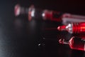 Close view of the glass syringes on a black background and red light. Medicine and health concept. Vaccine against viruses. Needle Royalty Free Stock Photo