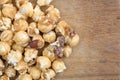 Close view of gourmet popcorn with nuts on cutting board