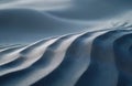 Close view of gray sand dunes with smooth wave like patterns. Natural textures form abstract shapes under soft light. Minimalist Royalty Free Stock Photo
