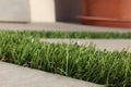 Close view of synthetic grass texture between tiles