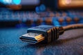 Close view of HDMI cable on a dark surface at a workspace Royalty Free Stock Photo
