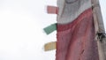 A close up on nepalese small wind lokta prayer flags blowing in the wind. Nepal. Beautiful flower field. View from a