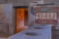 Close view inside ancient eating house in Pompeii, Italy
