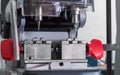 Close view of key copying machine with key. Duplicate machine make new key. Locksmith theme