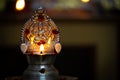 Close view of lit diya lamp. Lamp made out of silver metal lit during festival
