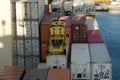 Close view on loading container attached to spreader of gantry cranes operated by stevedores