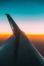 Close View Of Logotype Flydubai On Wing Of Aircraft. Plane At Sunset Sky. View From Airplane Window On Height Flight Of