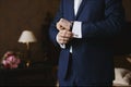 Close view of the luxury watches on the hand of a handsome businessman in a tuxedo and in a shirt with cufflinks Royalty Free Stock Photo