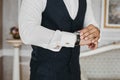 Close view of the luxury watches on the hand of a handsome businessman in a tuxedo and in a shirt with cufflinks Royalty Free Stock Photo