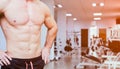 Close view of man's abs, chest and biceps at a gym Royalty Free Stock Photo