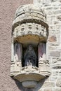 Medieval Pieta in a wall niche on the facade of a house in La Chaise-Dieu