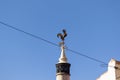 Cock rooster on top of chimney