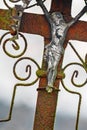 Close view of a metal crucifix on an old rusty cross