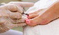 Close view of nails and feet with nail file. Royalty Free Stock Photo