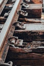 Close view of old railroad tracks dated 1902 with worn ties and gravel ballast