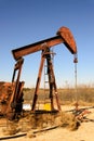 Old rusty oil derrick in sunlight with blue sky Royalty Free Stock Photo