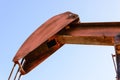 Old rusty oil derrick in sunlight with blue sky Royalty Free Stock Photo