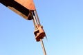 Old rusty oil derrick in sunlight with blue sky Royalty Free Stock Photo