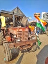 Close view of an old tractor parked in a ground by farmers