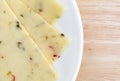 Close view of pepper jack cheese on a white plate