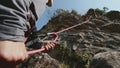 Close-Up of Climber Belaying Partner on Rocky Ascent