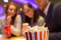 Close view popcorn being purchased by people at cinema