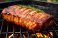 close view of pork loin roast on a grill grate