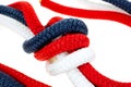 Close view of a red white and blue rope knot Royalty Free Stock Photo