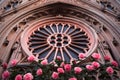 a close view of a rose window with surrounding gothic revival elements