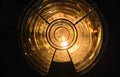 Close view of round Fresnel lens for lighthouses, lights on in dark room Royalty Free Stock Photo